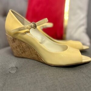 Franco Sarto Buttercup yellow cork patent leather wedges with ankle strap.